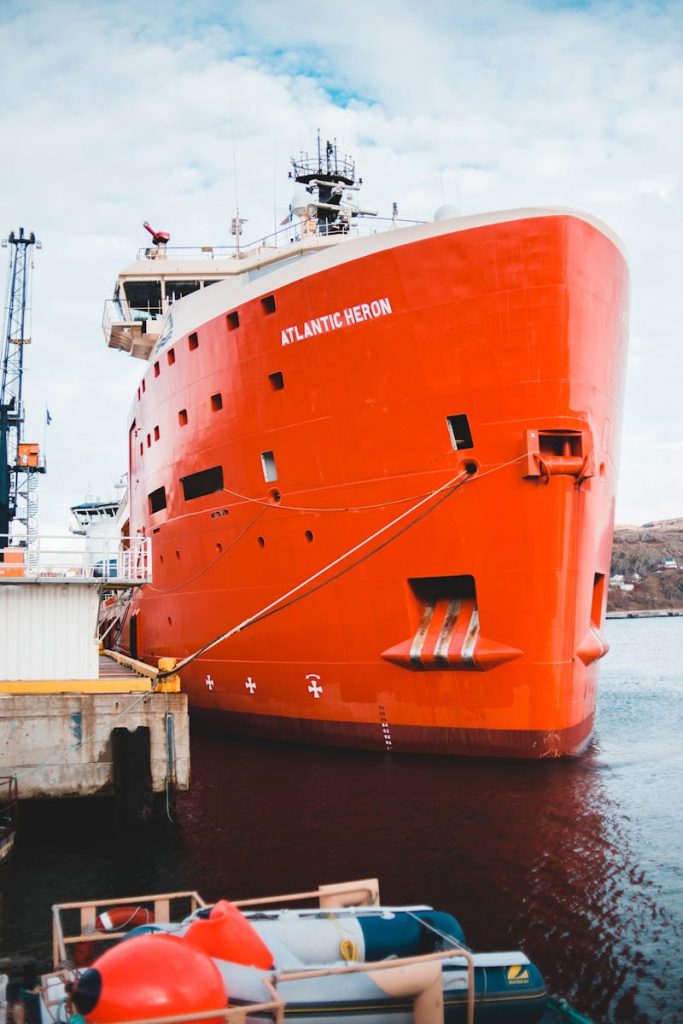 Orange and White Ship on Dock